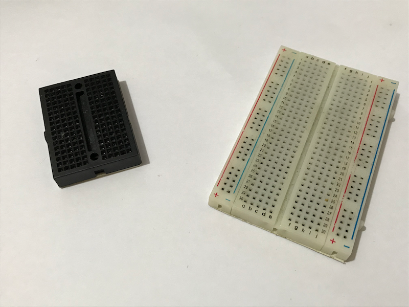 Bigger breadboards (right) have dedicated power and ground rails but the smaller ones (left) do not.