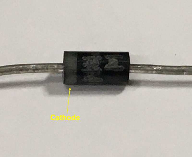 The cathode is indicated by the strip on the diode.